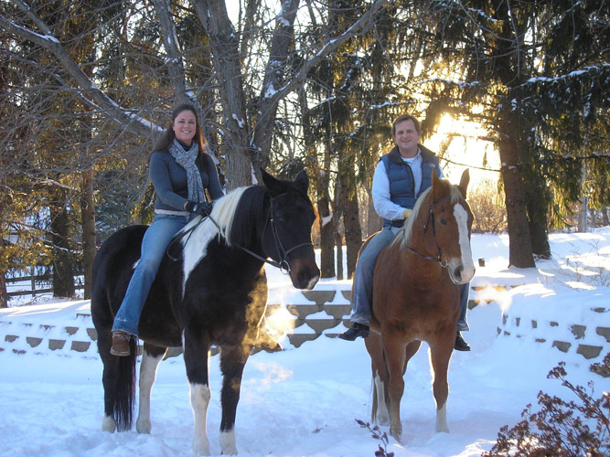 Seventh Farm: Tom and Liz McCadden on horseback in the foreground of their snowy stables